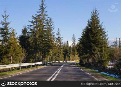 Travelling by car. The track in the mountains through the forest. Polish Tatras. Travelling by car. The track in the mountains through the forest. Polish Tatras.