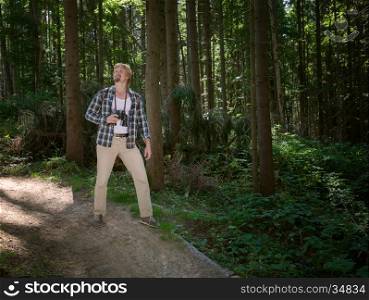 Travelling man walking in summer forest