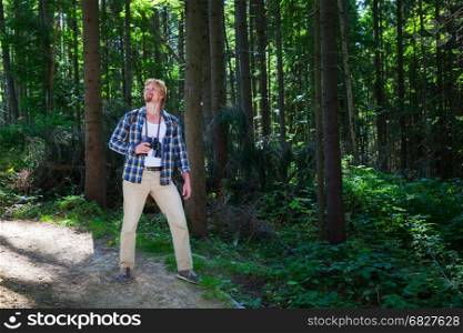 Travelling man walking in summer forest