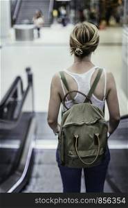 Travelling scene at a train station: young girl and a stairway