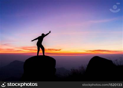 travels Silhouette on the peak of mountain,success concept
