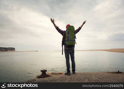 TraveMan Traveling Backpack with arms raised feeling the gratitude