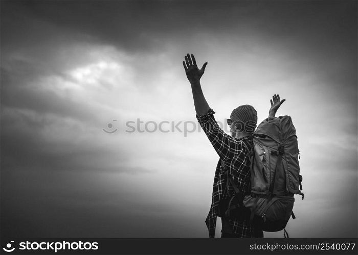 TraveMan Traveling Backpack with arms raised feeling the gratitude