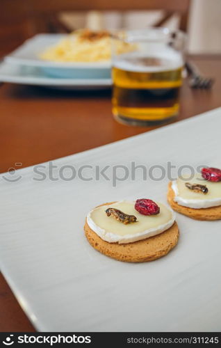 Tray of cheese canapes with fried crickets. Tray of canapes with crickets