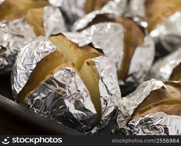 Tray of Jacket Potatoes Wrapped in Foil