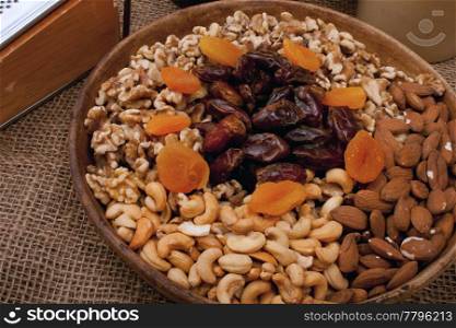 Tray with walnuts, almonds, cashews, dates and apricots