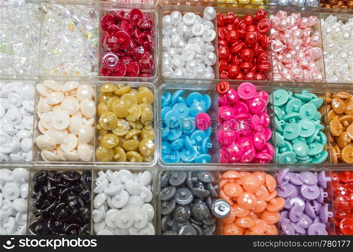 Trays of coloured buttons