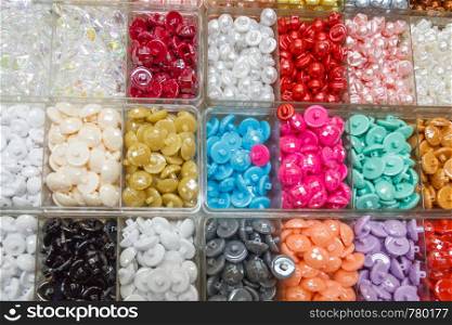 Trays of coloured buttons