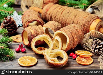 Trdelnik is a baked delicacy on a spit and charcoal dough with sugar, cinnamon and vanilla. Christmas sweets, street food. Czech and Moravian cuisine.