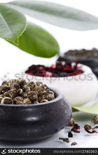 tree kinds of tea in bowls on white background