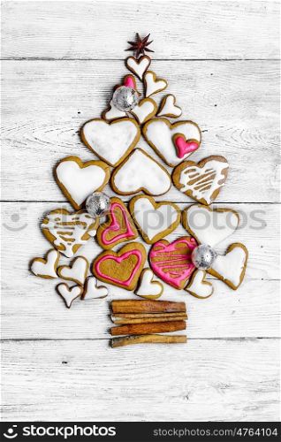 Tree of Christmas cookies. Christmas cookies are laid out in the shape of Christmas tree on light wooden background