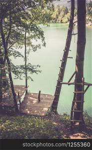 Treehouse wooden platform at a beautiful blue lake