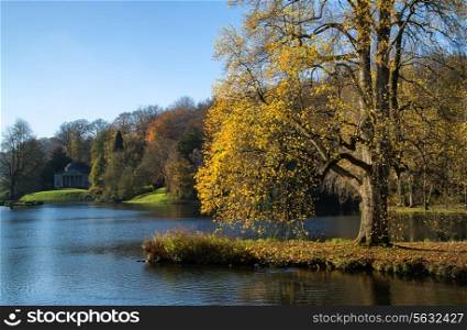 Trees and main lake in Stourhead Gardens during Autumn.