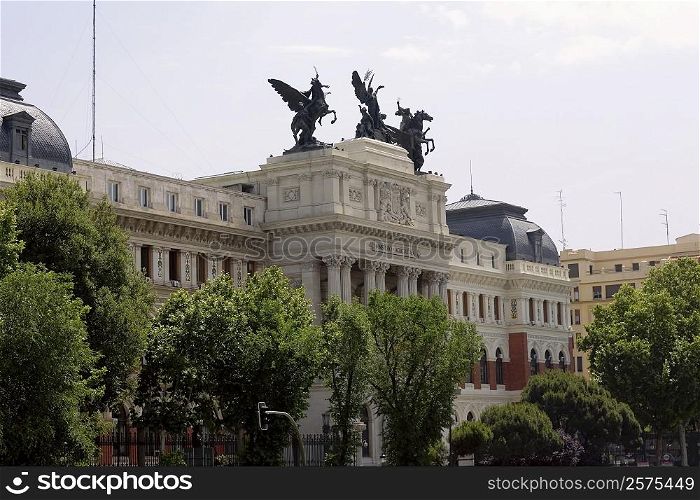 Trees in front of a government building, Ministry Of Agriculture Building, Madrid, Spain