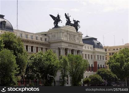 Trees in front of a government building, Ministry Of Agriculture Building, Madrid, Spain