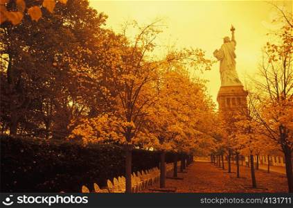 Trees in front of a statue, Statue Of Liberty, New York City, New York State, USA