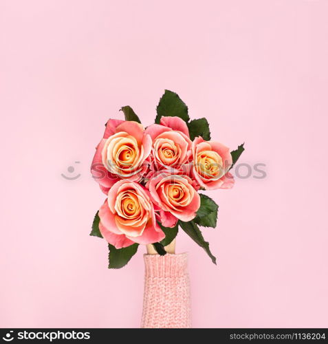 Trendy banner for Valentines Day, International Womens Day or mothers day, Beautiful bouquet of pink roses in a female hand. Top view.. Beautiful bouquet of pink roses in a female hand. Top view.