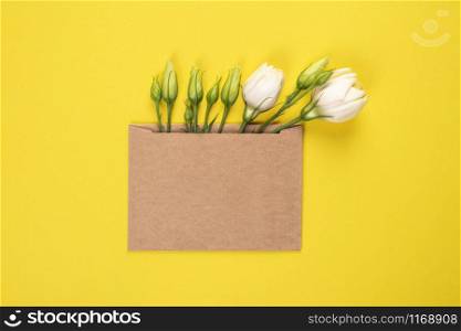 Trendy banner for Valentines Day, International Womens Day or mothers day. Party or wedding invitation. Eustoma flower arrangement with flowers and blank card, on yellow background. Eustoma flower arrangement with flowers and blank card, on yellow background