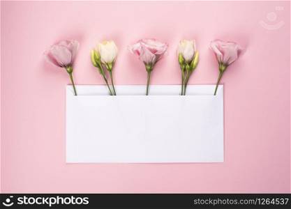Trendy banner for Valentines Day, International Womens Day or mothers day. Party or wedding invitation. Five Eustoma flower arrangement with flowers and blank card, on pink background. Five Eustoma flower arrangement with flowers and blank card, on pink background