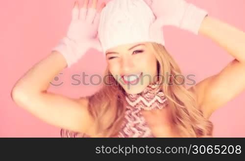 Trendy blonde lady in winter fashion facing out of frame with copyspace