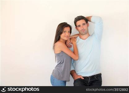 Trendy couple standing on white background