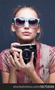 Trendy girl in glasses playing the ape with camera. Duckface. Pouting lips