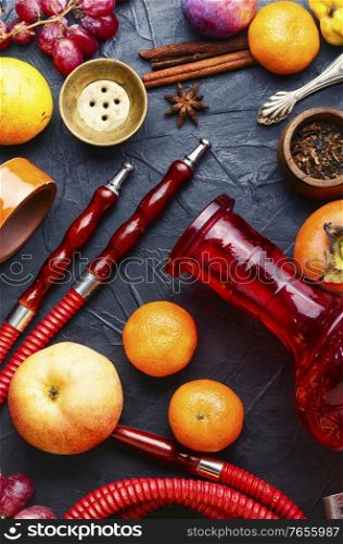 Trendy hookah with fresh fruit aroma.Tobacco fruit shisha. Turkish hookah on fruits