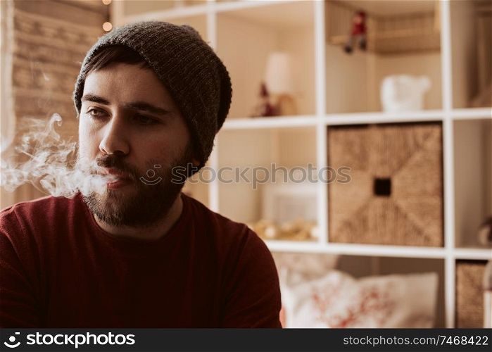Trendy man using a vaper - Christmas and Winter Season