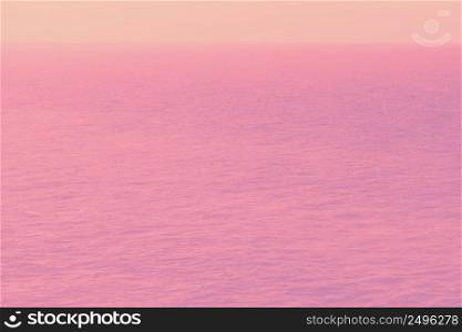 Trendy pink toned aerial view of calm infinite ocean water and sky. Fantasy alien planet ocean concept.