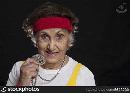 Trendy senior woman holding locket
