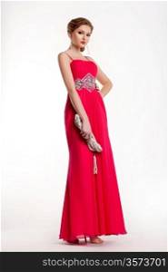 Trendy stylish fashion model in long red dress posing