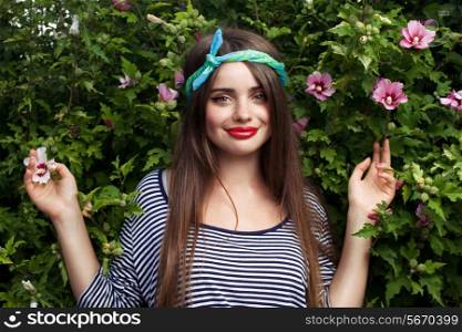 trendy teenager model with kerchief posing on flowers BG