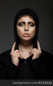 Trendy Young Woman in Hood over Black Background