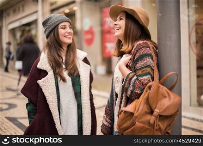 Trendy young women shopping in the city