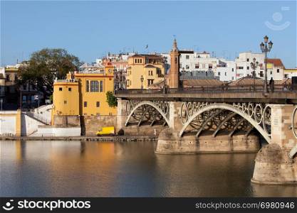 Triana Bridge (Isabel II Bridge) from 19th century on Guadalquivir river in the city of Seville, Spain.