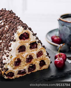 Triangle cherry cake with cream and chocolate sprinkles