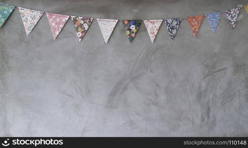 Triangle papers hanging on the grey wall decoration in house, stock photo