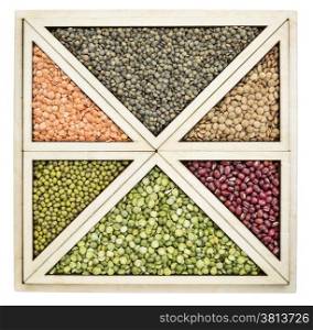triangles and squares abstract - a variety of beans and lentils in an isolated wooden tray inspired by Chinese tangram puzzle