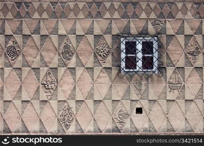 Triangular, rectangular and rhombus symmetrical pattern design with marine motifs on the historic house wall in the Old Town of Gdansk in Poland