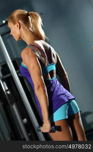 Triceps workout. Image of fitness woman in gym working out