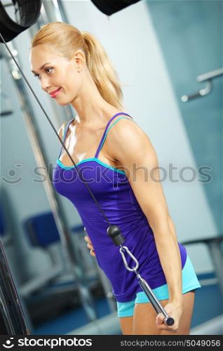 Triceps workout. Image of fitness woman in gym working out