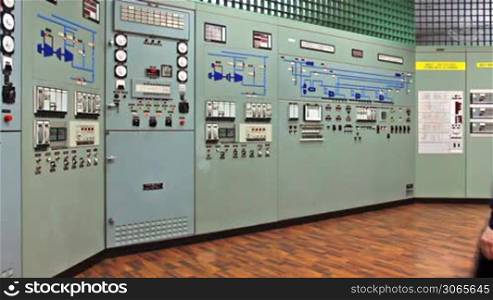 triggered audio-visual emergency warning alarms on main control panel of compressor station, engineer comes and disables it, wide viewing