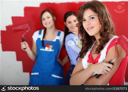 trio of handygirls painting room red