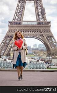 trip across Europe. girl with a balloon in the shape of a hearton the background of the Eiffel Tower in Paris. France
