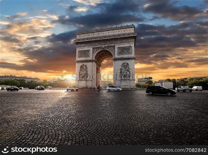 Triumphal Arch and clouds at sunrise in Paris, France