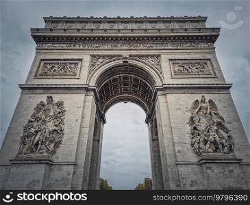 Triumphal Arch  Arc de triomphe  in Paris, France. Closeup architectural details of the famous historic landmark  