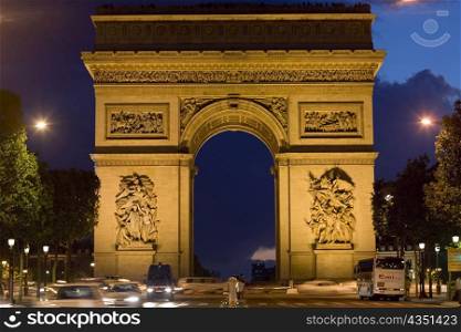 Triumphal arch lit up at night, Arc De Triomphe, Paris, France