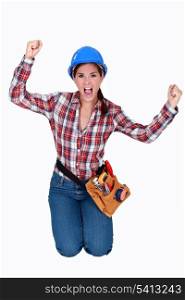 Triumphant female construction worker