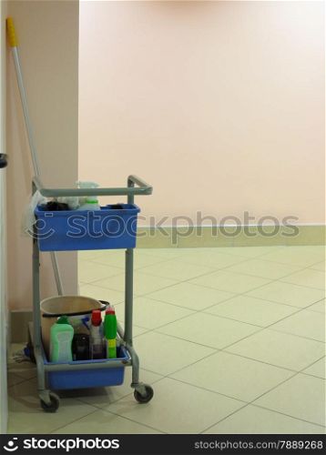 Trolley for cleaner with cleaning equipments. Janitor cart in a hall.