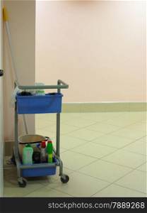 Trolley for cleaner with cleaning equipments. Janitor cart in a hall.